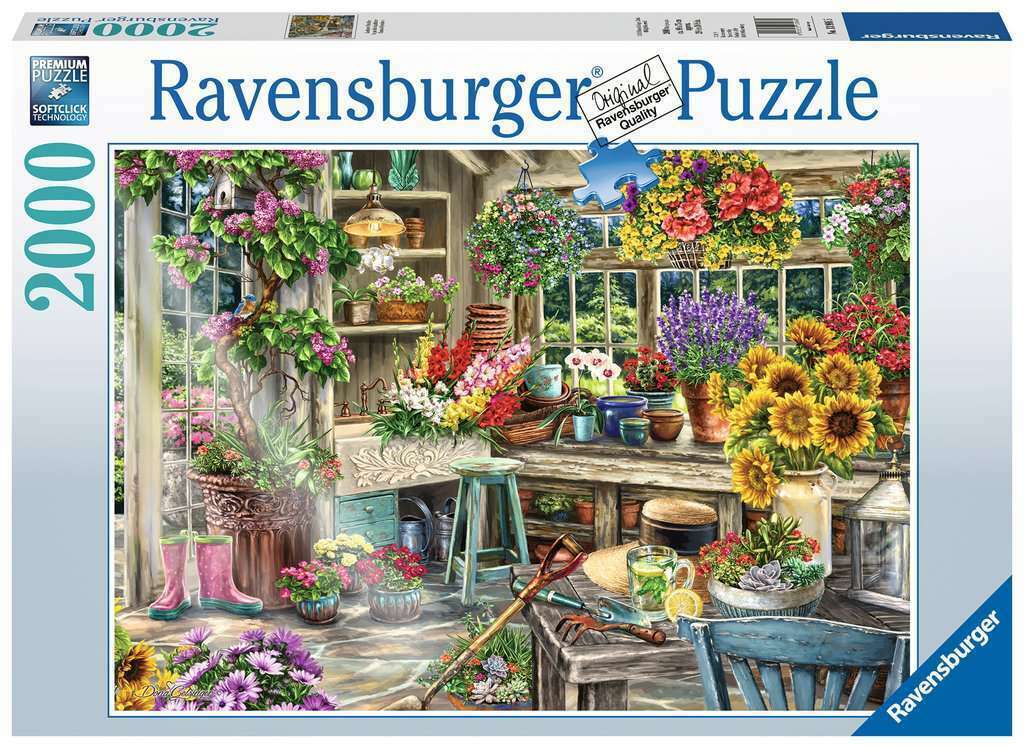Ravensburger branded packaging with completed puzzle image on cover. Image shows greenhouse with, assorted flowers in pot plants, gumboots, gardening tools and more.